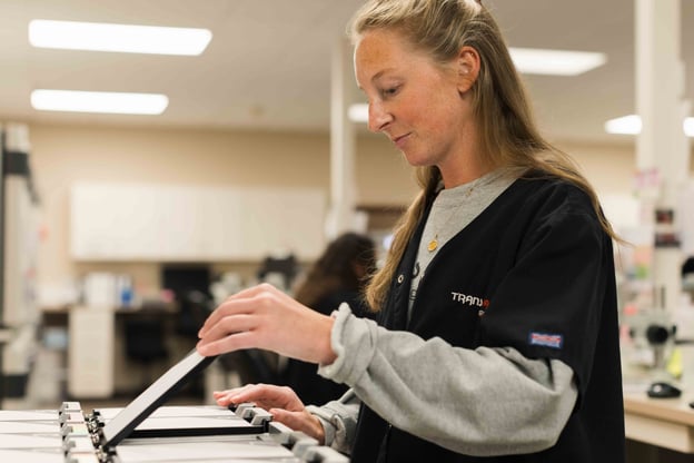 Lab technician working with samples in genetics testing equipment.