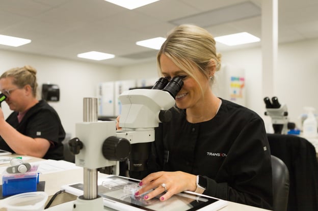 Woman sitting at a microscope